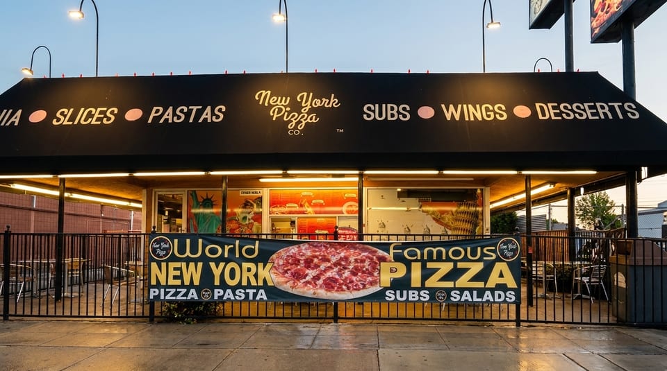 New York Pizza Co. storefront with a black awning listing menu items and a banner advertising "World Famous Pizza."
